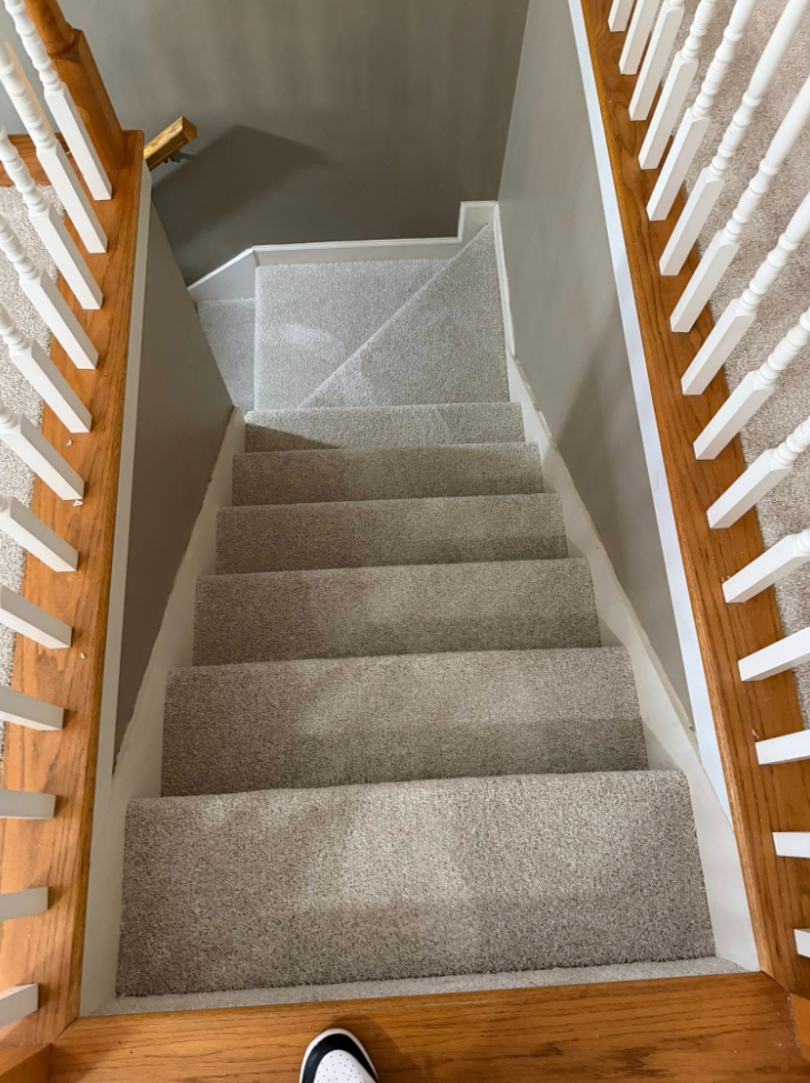 Carpet staircase with oak railing